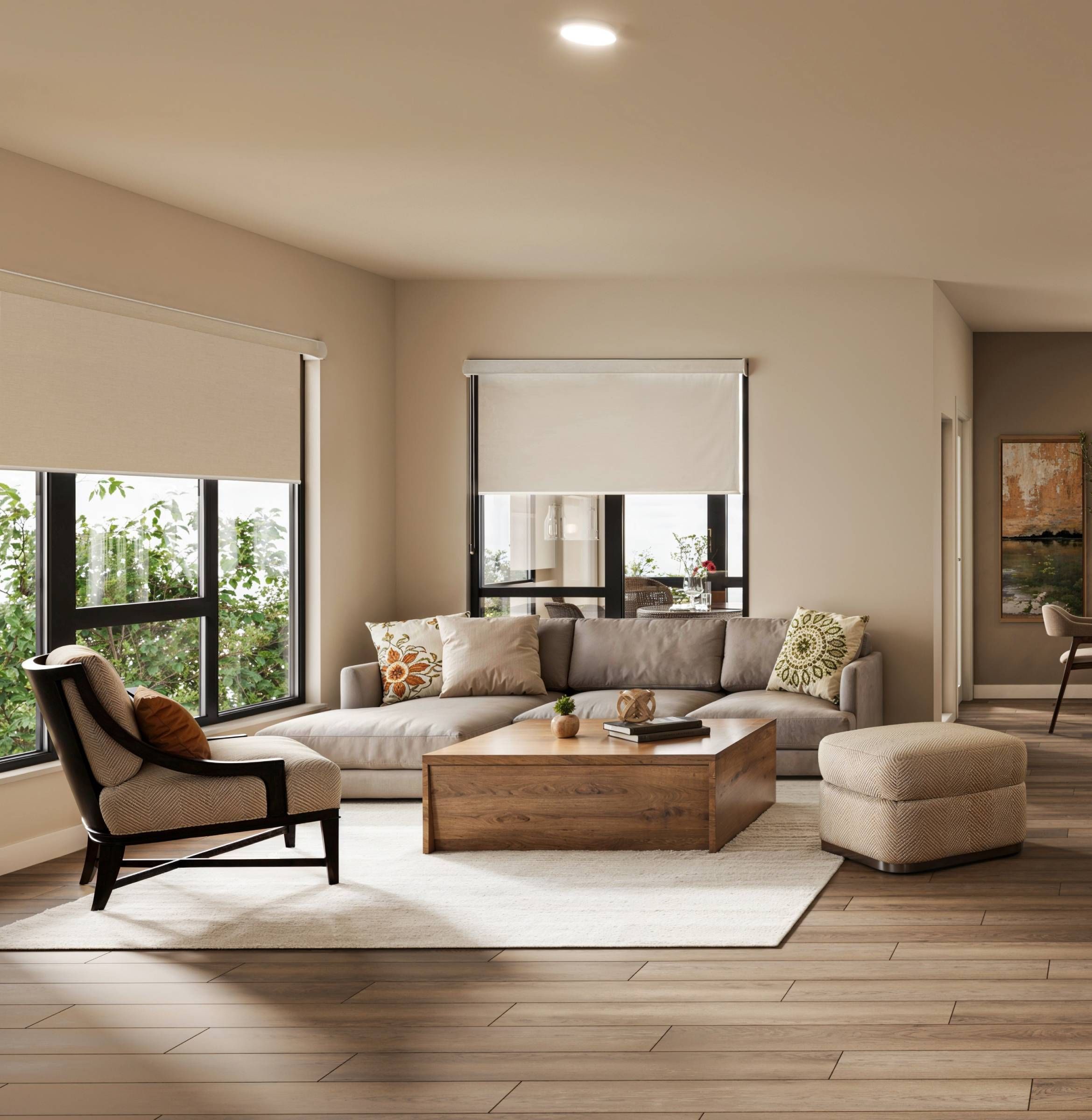 The Ensley 55+ Luxury Apartments with Modern living room with a gray sectional, patterned pillows, wooden coffee table, and large windows.