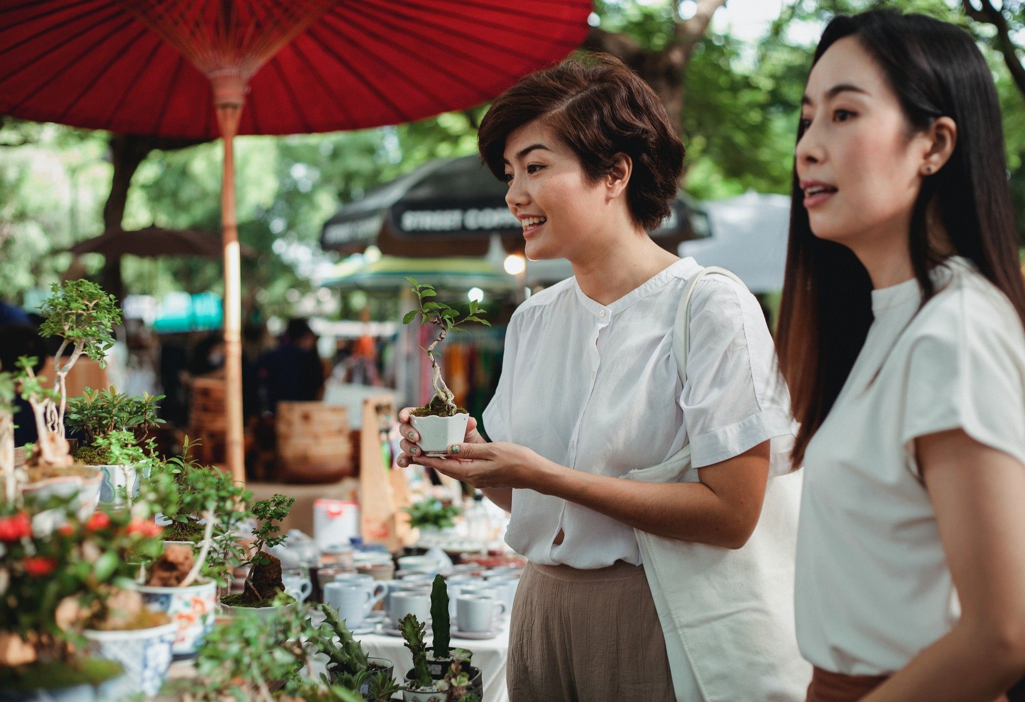 Young Women Shopping at Outdoor Farmer's Market